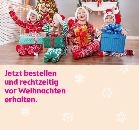 Vier Kinder in Weihnachtsoutfits sitzen mit Geschenken vor dem Baum, links Hinweis zur rechtzeitigen Bestellung zu Weihnachten.